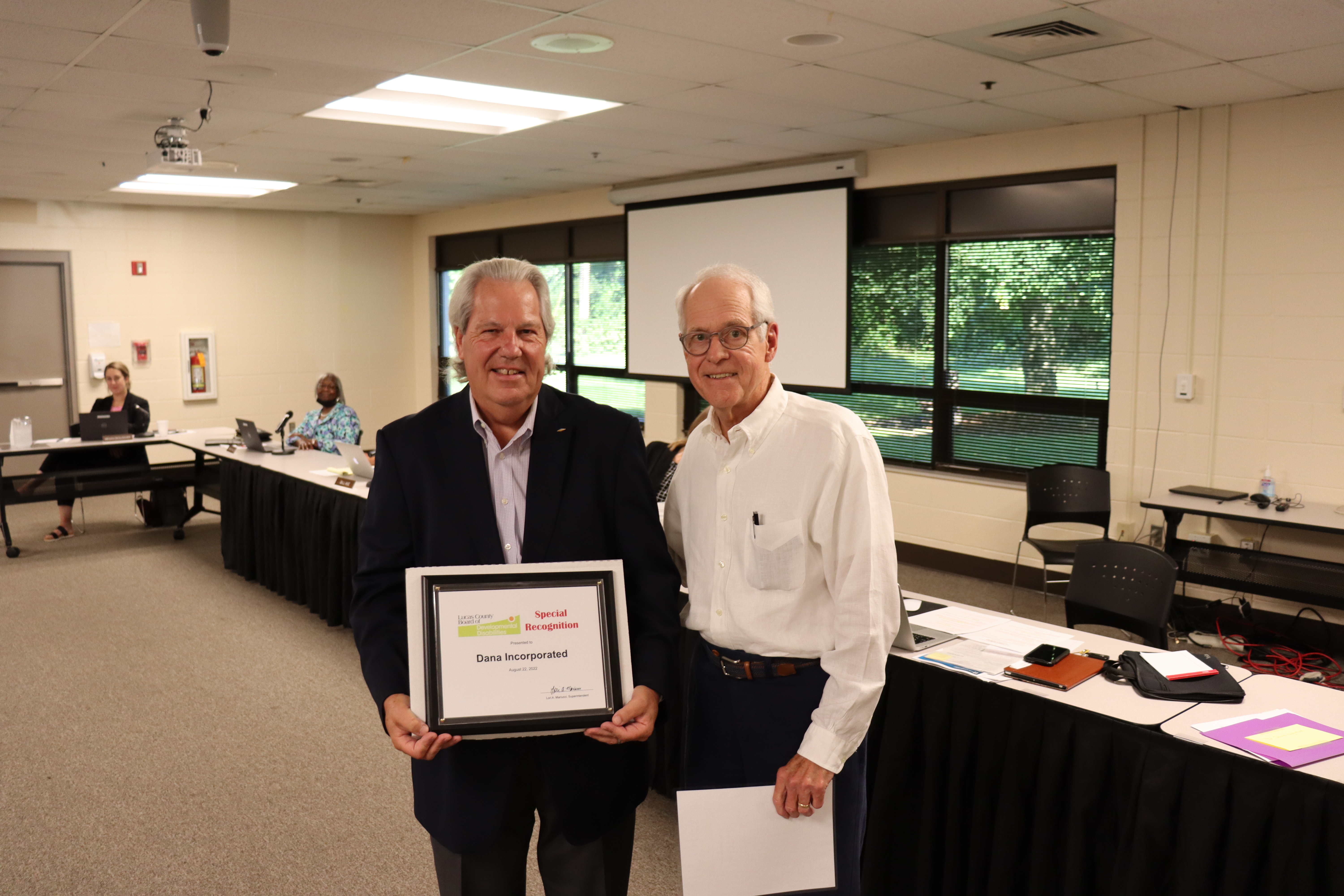 Rod Filcek, retired Dana employee, and tournament chair of the AJGA Dana, Inc. Junior Open with Board President Ron Volk. 