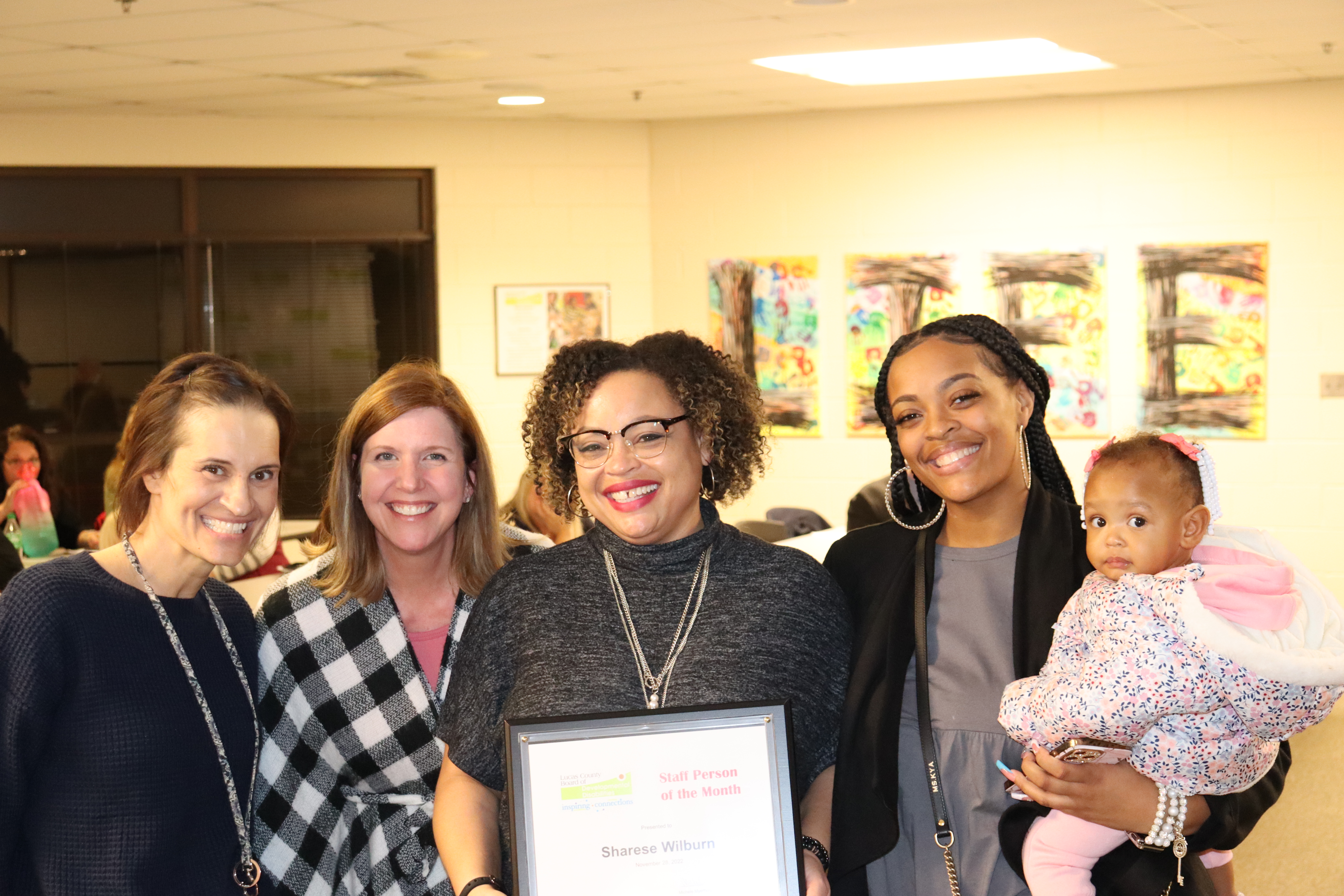 Sharese with family, boss Lori Balogh, and colleague Jenny Leimann