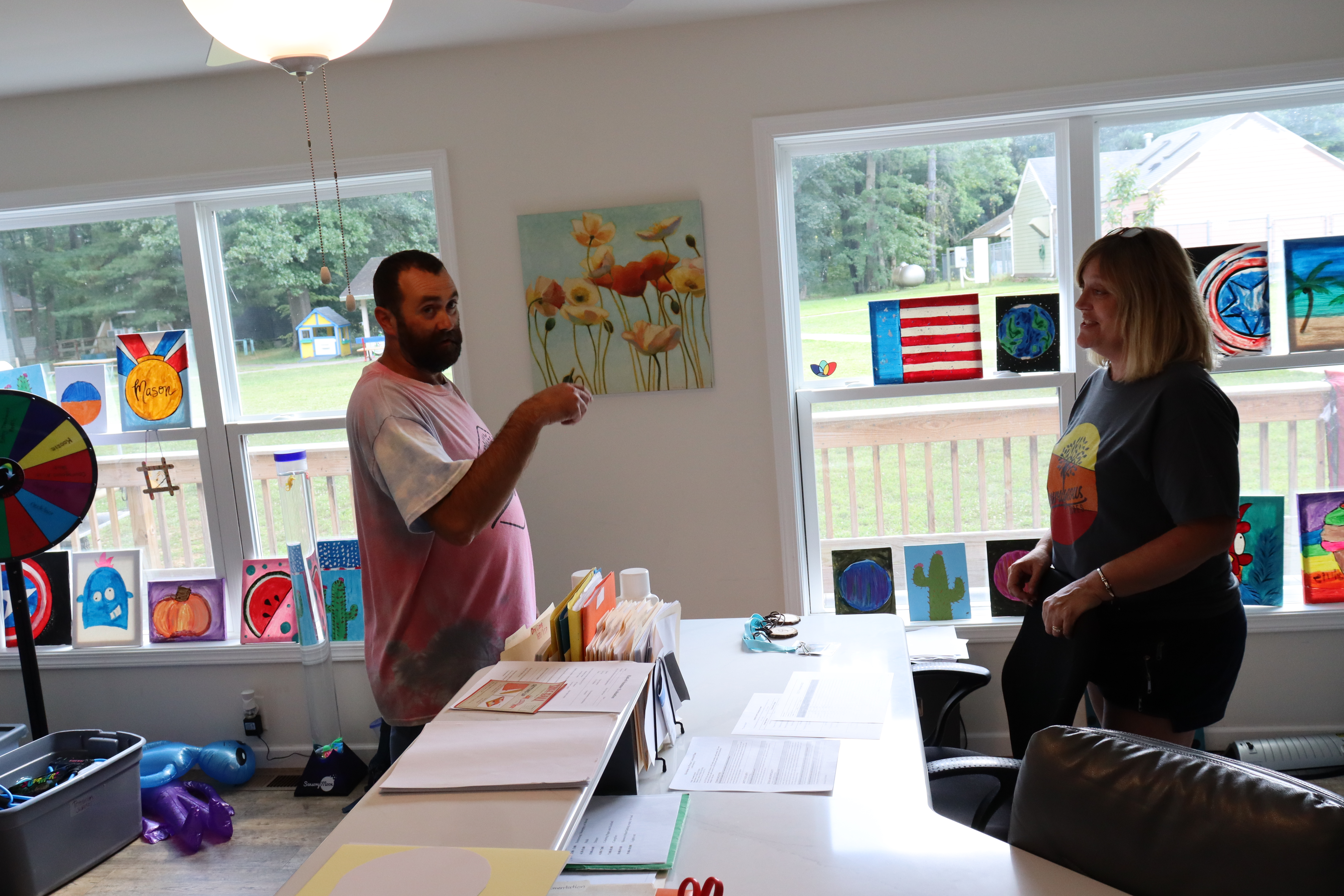 Jeremy talking to Courageous Community Services Executive Director Laura Kuhlenbeck inside the office at Courageous Acres.