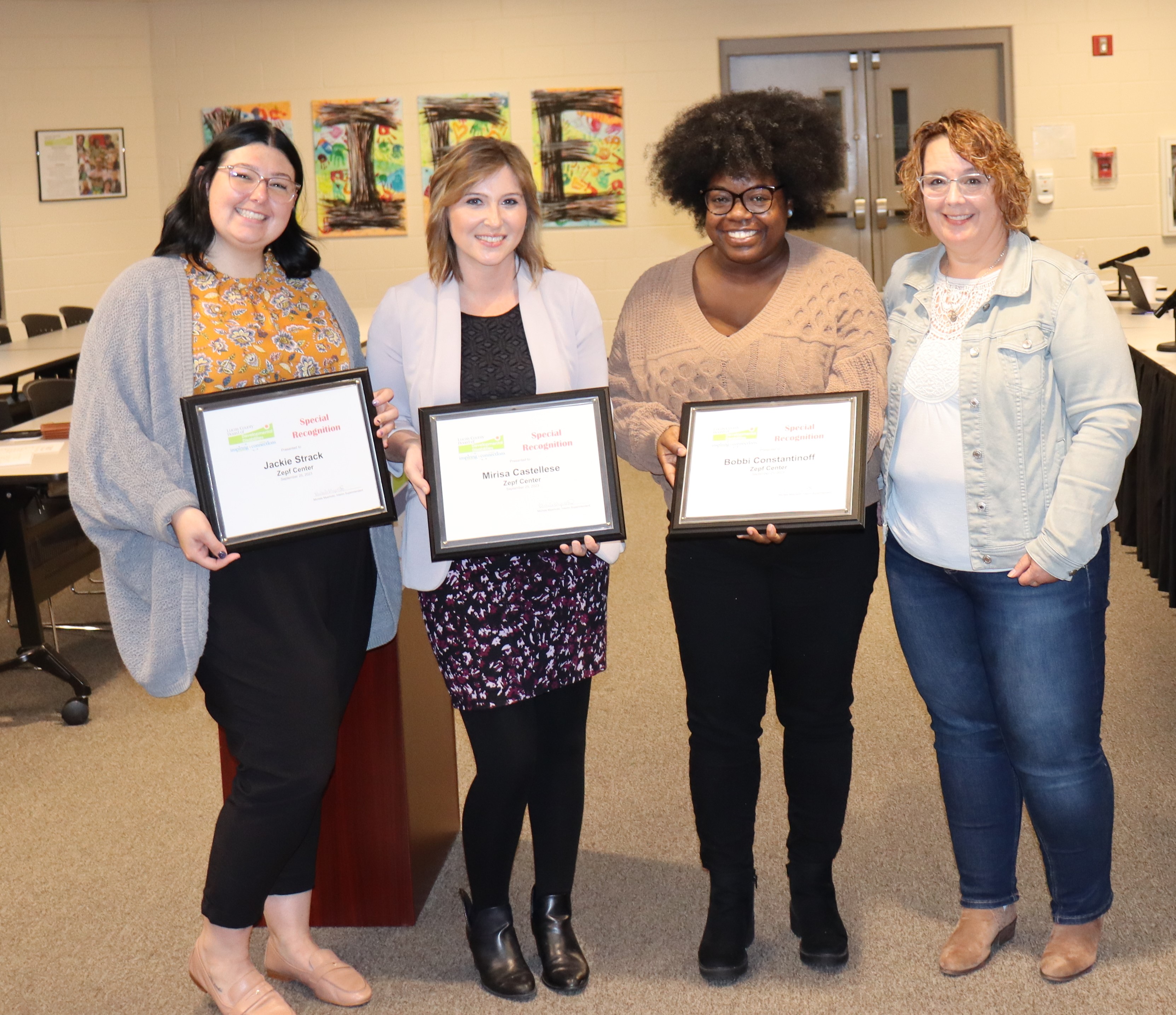 Three ladies from Zepf Center holding their awards with Lucas DD's Teresa Miller on the right.