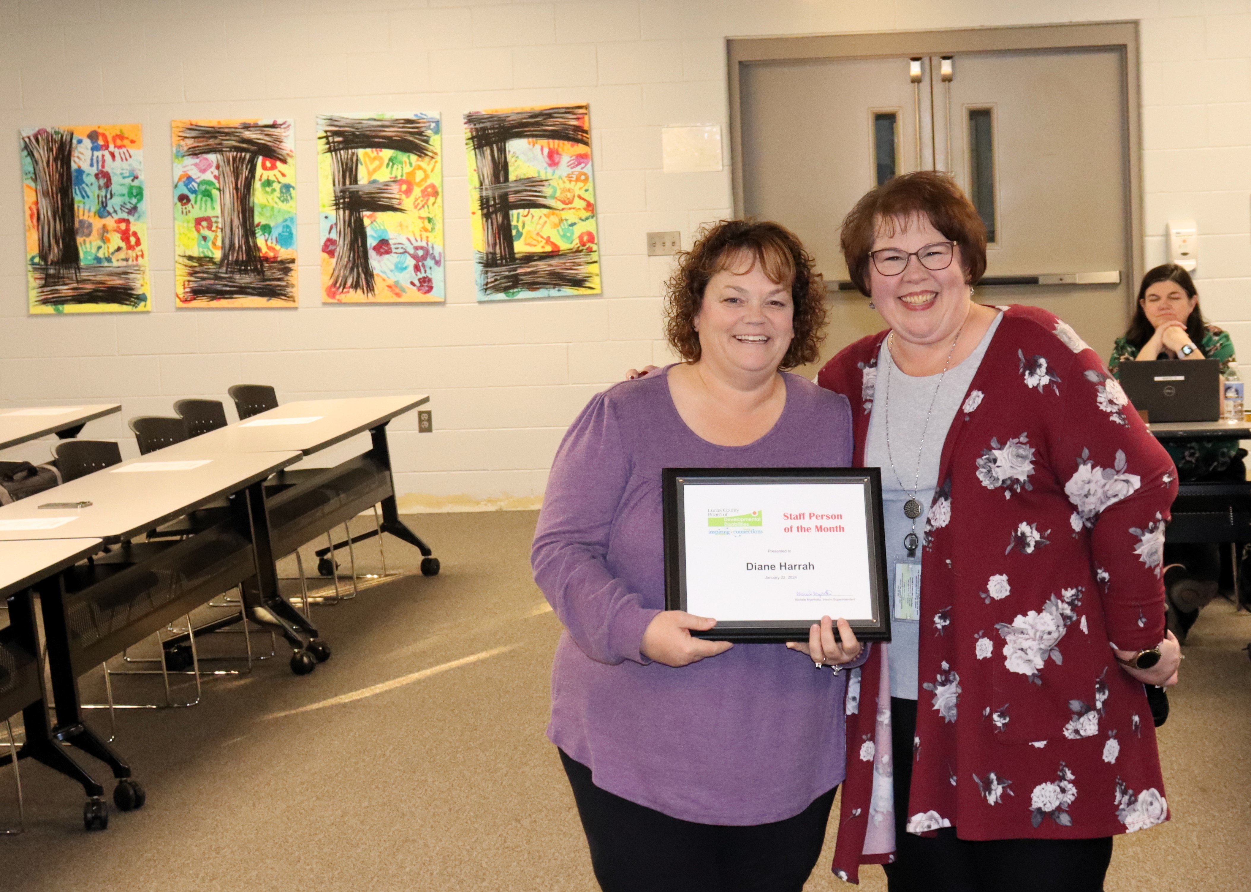 Lucas DD Physical Therapist Diane Harrah, left, with Early Intervention Developmental Specialist Theresa Grimes at the Board meeting.