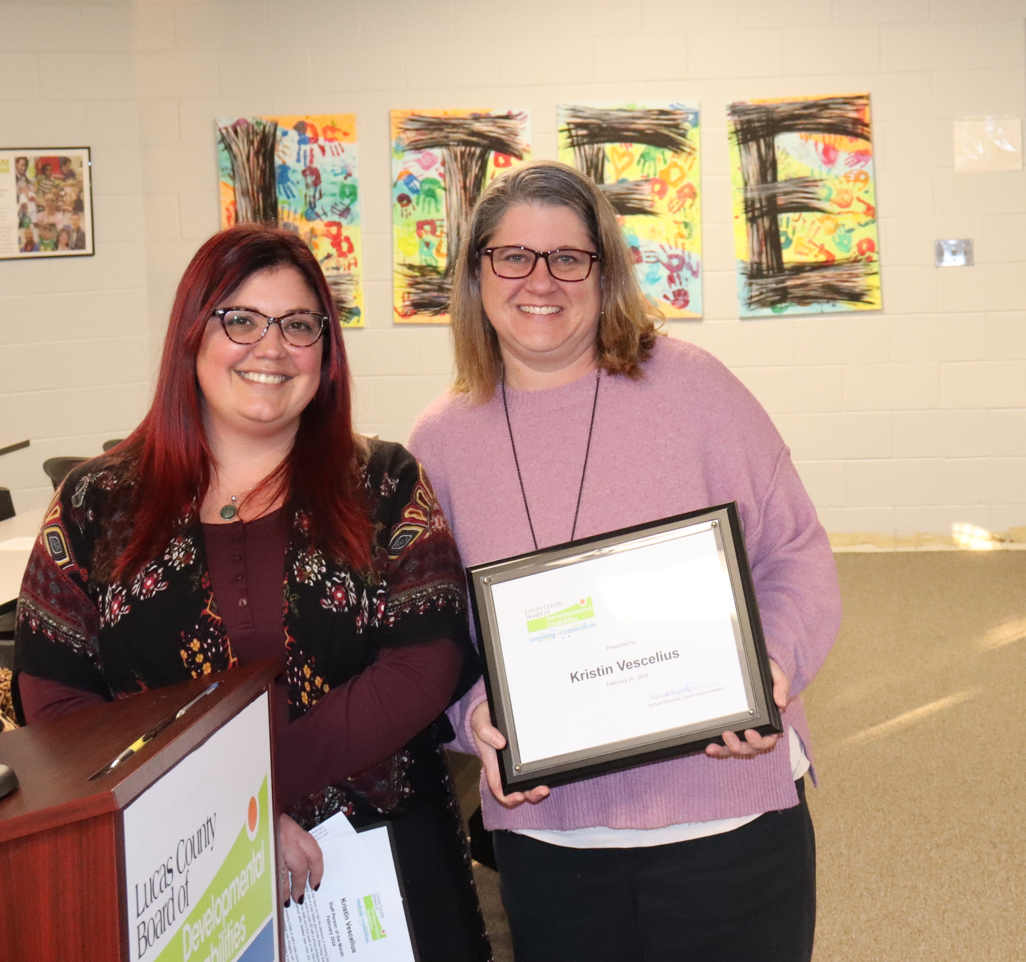 SSA Coordinator Sarah Dodson, left, with SSA Kristin Vescilius on the right standing by a podium.