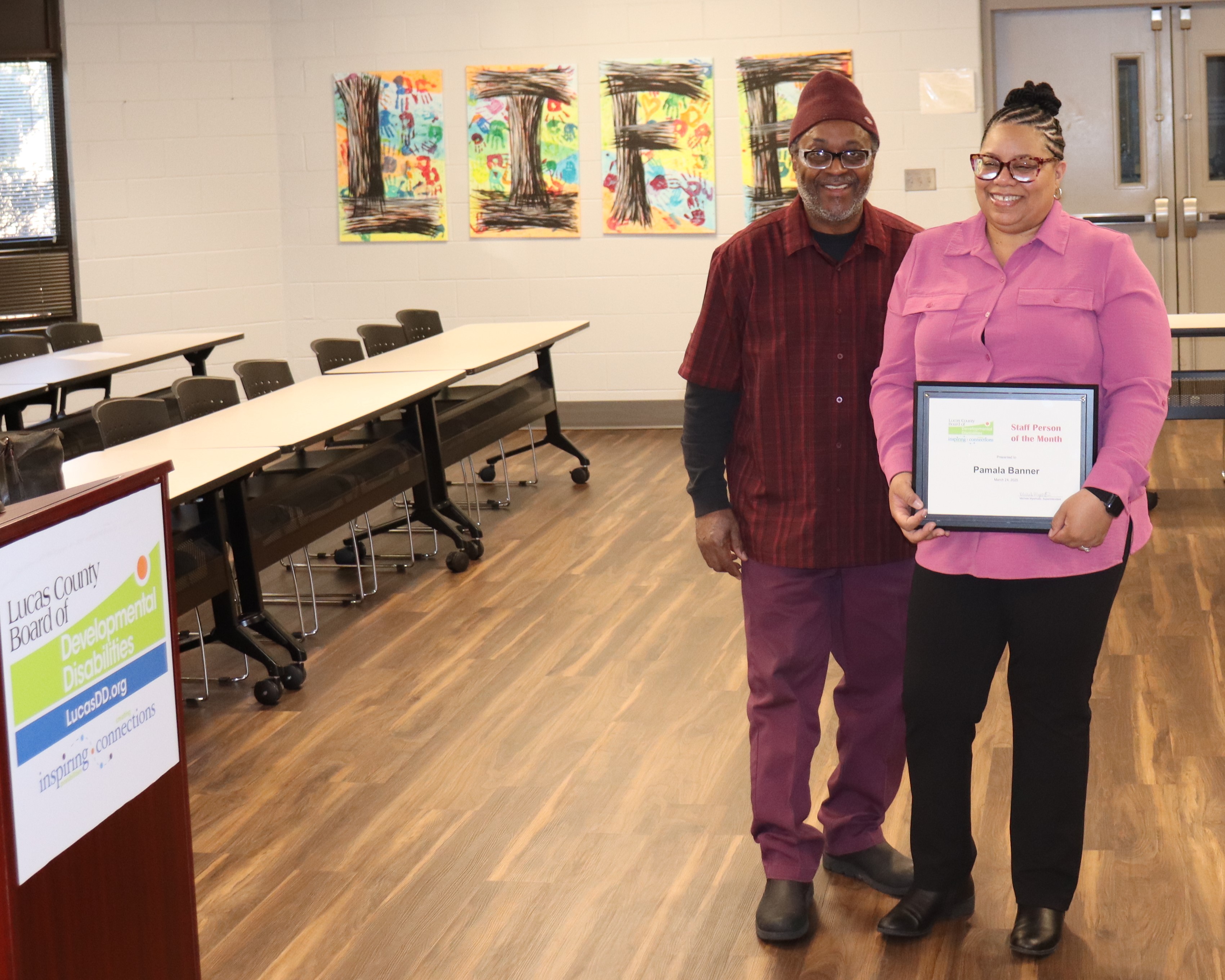Pamala Banner, with husband Aaron, accepts the award