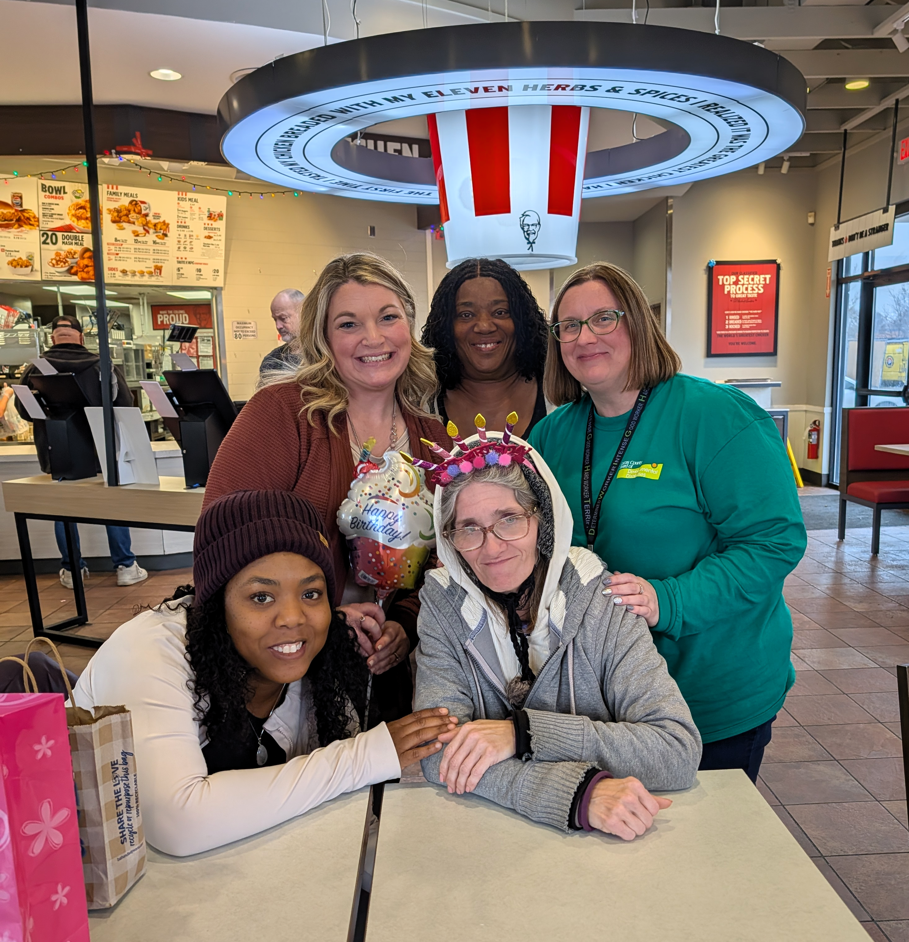 4 women at a lunch table inside a KFC restaurant