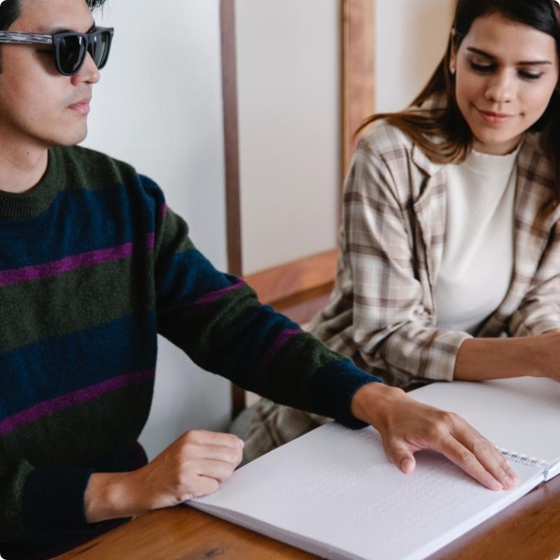 Individual with Visual Impairment Reading Braille