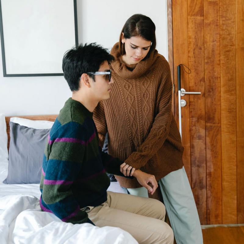 A Woman Assisting an Individual with Visual Impairment