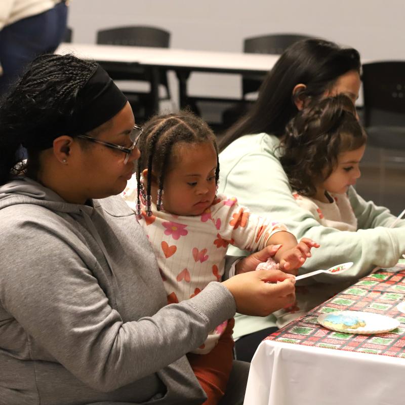 Mother and child decorating a cookie