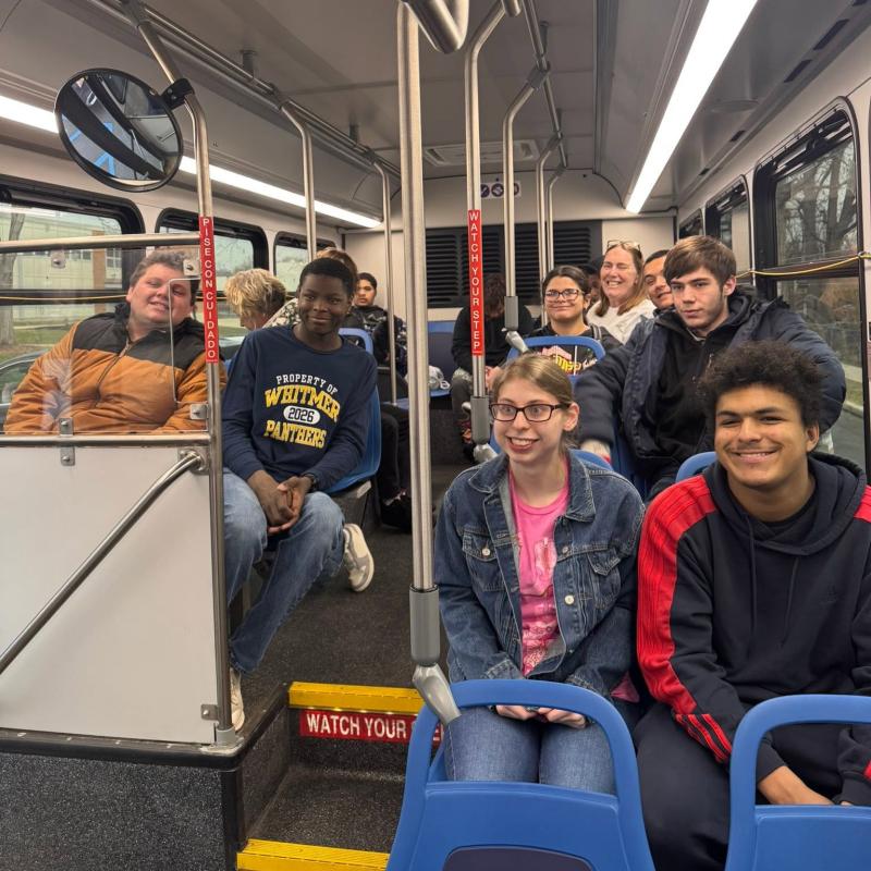 Young adults riding on a bus
