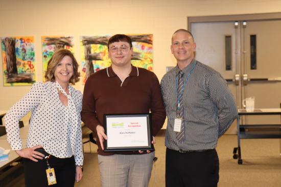 Alex Huffaker, center, with Lucas DD's Lori Balogh and Gary Arbuckle