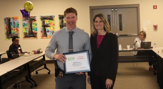 Jeff Newton holds award as he poses with Lucas DD Interim Superintendent Michele Myerholtz